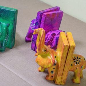 Handcrafted curio bookends featuring carved safari animals, made by Kenyan artisans.