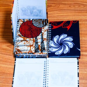 African Kitenge print notebooks with colorful fabric covers.