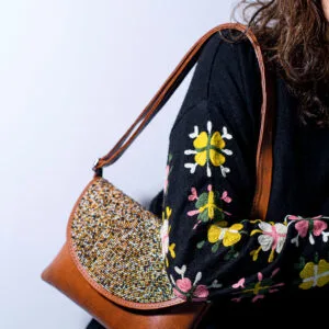 Handcrafted PU leather clutch bag with African beadwork, made in Kenya.