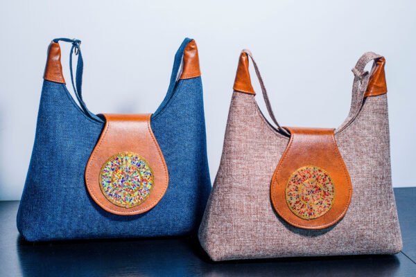 Set of two handmade leather bags, including a large handbag and a smaller crossbody bag