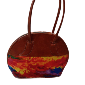 Oval-shaped leather handbag decorated with colorful African kitenge fabric