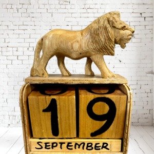 Handcrafted wooden block calendar featuring carved African wildlife animals, 4 x 3 inches, made in Kenya.