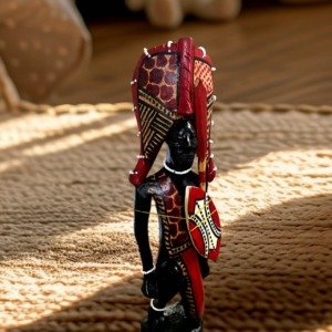 Handcrafted kneeling Maasai sculpture showcasing African culture and traditional attire from Selections Souvenirs