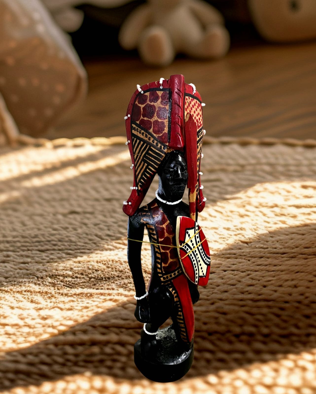 Handcrafted kneeling Maasai sculpture showcasing African culture and traditional attire from Selections Souvenirs